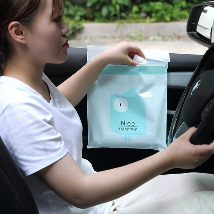 Aqua car garbage bag held open in the car, showing cartoon face label
