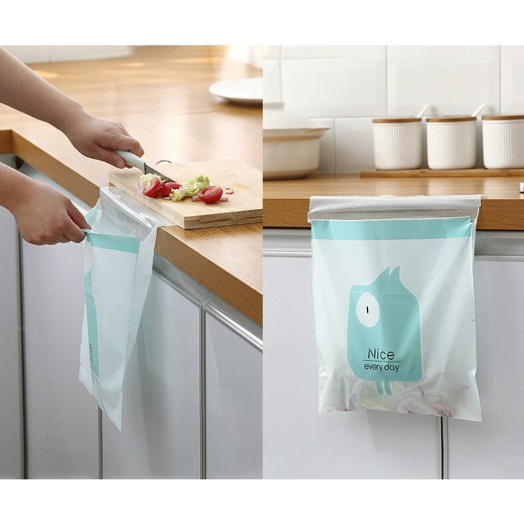 Aqua trash bag with cartoon face graphic, in use at a kitchen counter