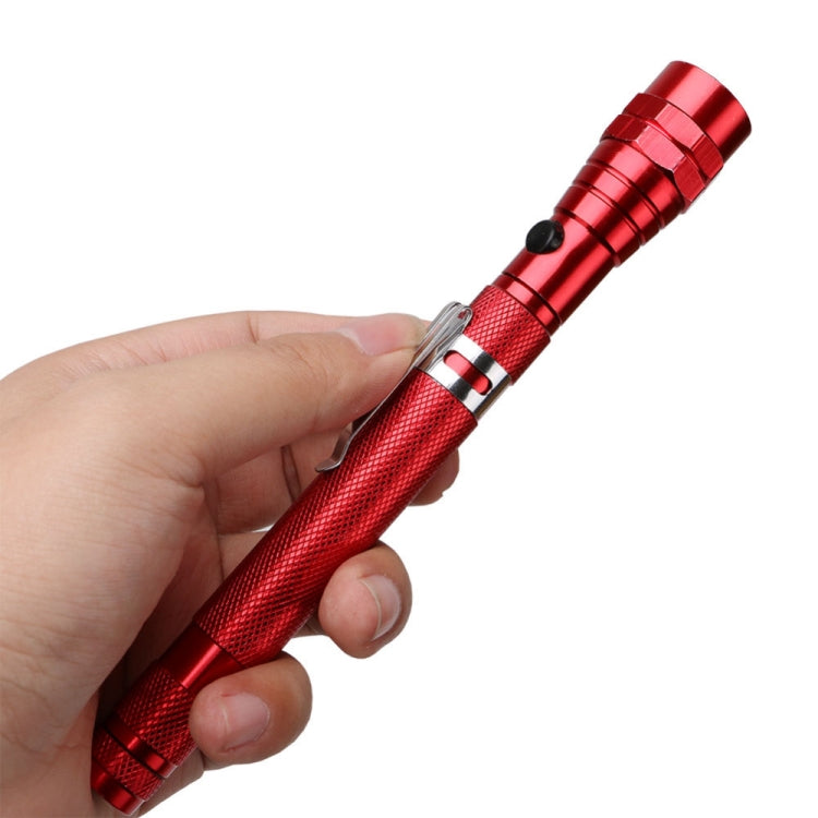Red flexible telescopic magnetic flashlight held in hand with clip detail
