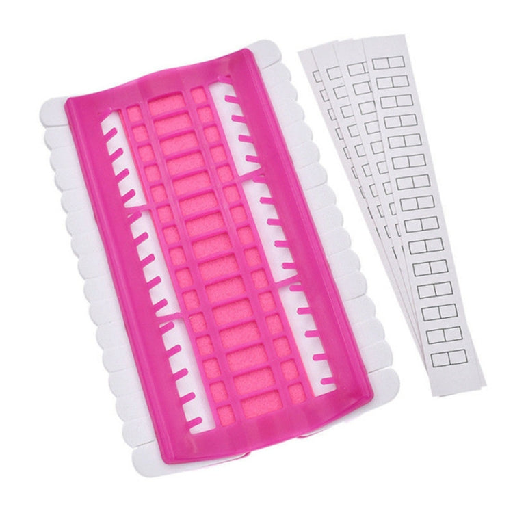 Pink cross-stitch thread organizer tool with open grid and included white template strip