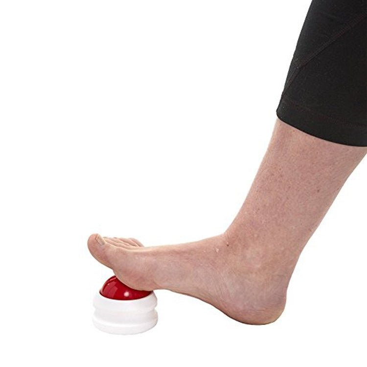 Red massage roller ball massager used on foot, white base visible.