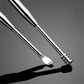 Close-up of stainless steel ear cleaning tools with rounded scoop and ribbed tip