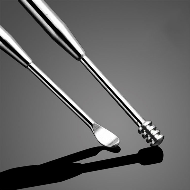 Close-up of stainless steel ear cleaning tools with rounded scoop and ribbed tip