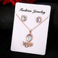 Rose-gold tone opal crystal pendant necklace with stud earrings on jewelry card