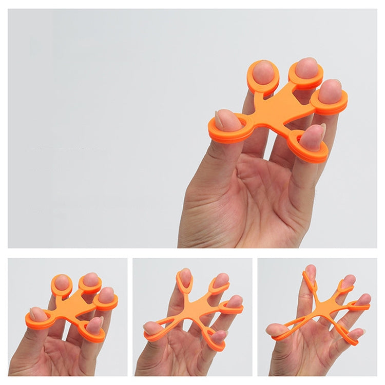 Orange silicone humanoid finger exercise pull ring held in a hand, five loops.