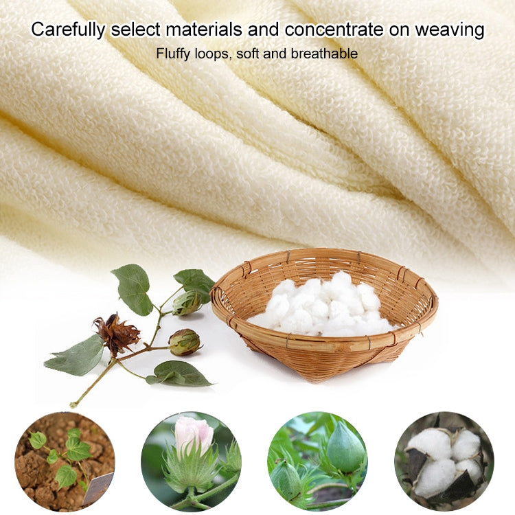 Cream cotton bath towel with plush, looped terry texture and soft drape.