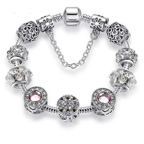 Silver-tone charm bracelet with pink crystal center bead, clear faceted beads, lobster clasp