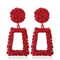 Red geometric trapezoid long dangle earrings with textured round tops