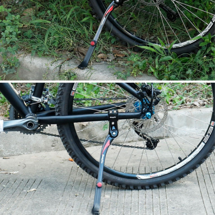 Bicycle kickstand extended with black foot and red release button