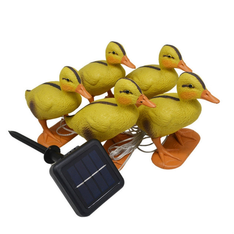 Yellow duck solar stake light set with orange bases and attached clear connection wire