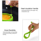 Green round silicone egg ring mold with metal handle, held by hand.