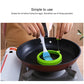 Green round silicone egg ring mold in skillet, oil brushed inside the ring.