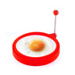 Red silicone round fried-egg ring with handle, holding a sunny-side-up egg
