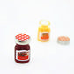 Mini strawberry jam jar with checkered lid, plus small spare lid and label plate
