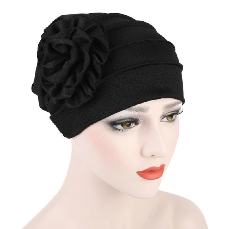 Women’s black turban hat with side rosette flower detail, adjustable fit