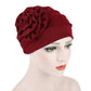 Women’s red turban hat with side rosette flower detail, adjustable fit