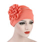 Women’s coral/orange turban hat with side rosette flower detail, adjustable fit