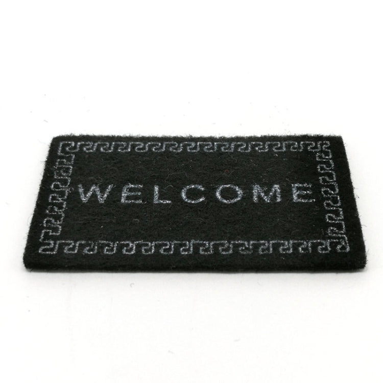 Black dollhouse welcome floor mat with 'WELCOME' lettering and border trim
