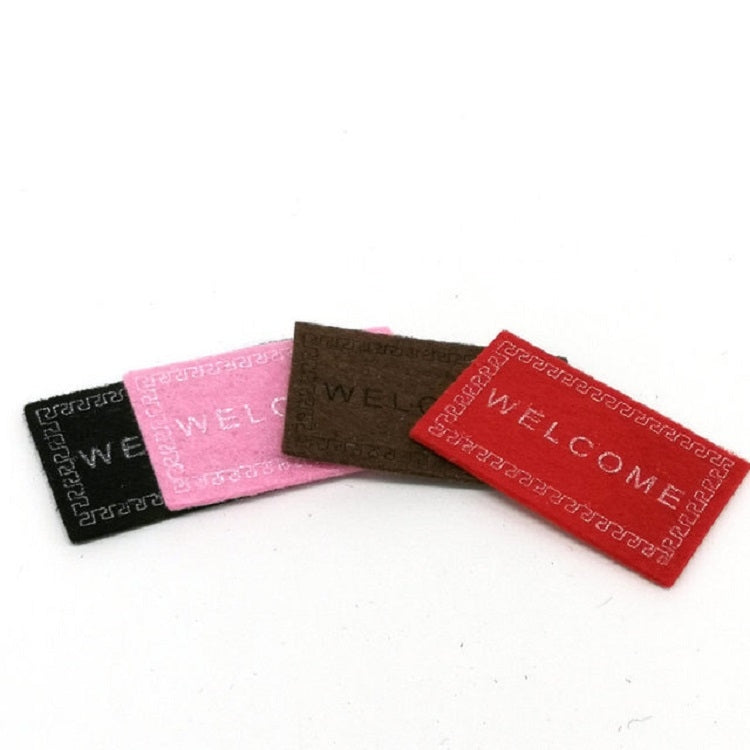 Set of mini welcome mats in black, pink, brown, and red with 'WELCOME'