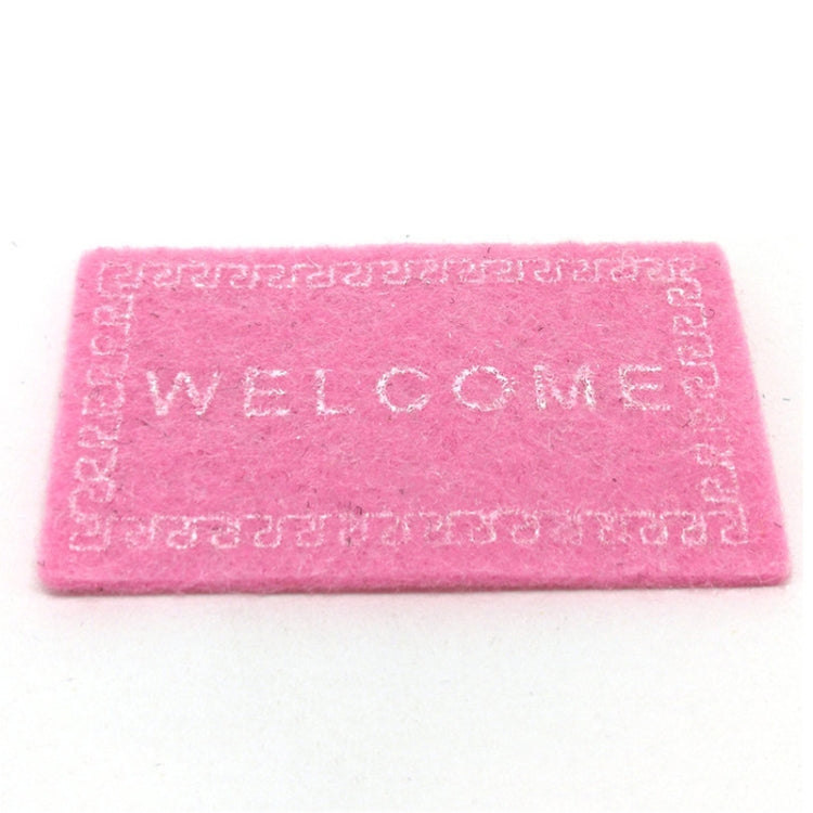 Pink dollhouse welcome floor mat with 'WELCOME' text and Greek-key border
