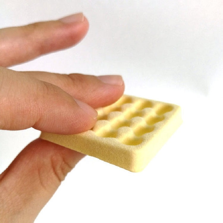 Mini egg carton toy held in hand, yellow tray with molded egg cavities