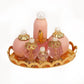 Mini doll house cosmetic set: four pink bottles with pearl tops on gold tray
