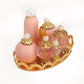 Mini doll house cosmetic set with pink and clear bottles, gold tray base