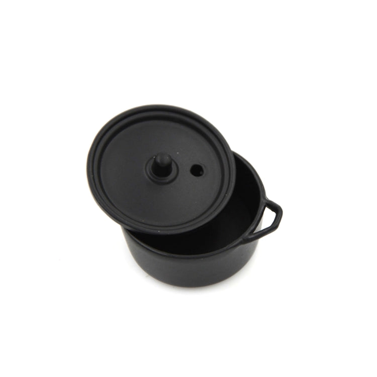 Miniature black alloy cooking pot with lid, side handles, and raised lid knob