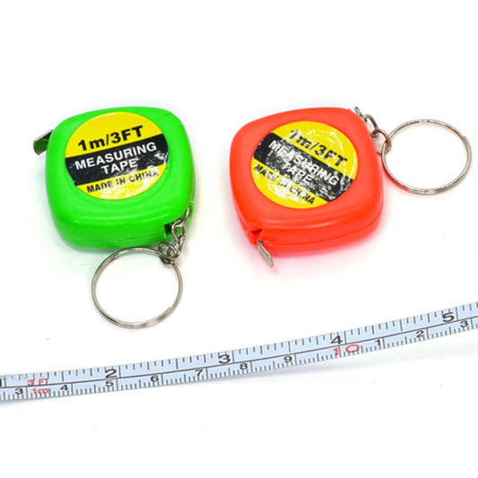 Green and red retractable square tape measure key rings with metal key loops; tape extended