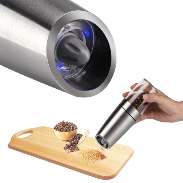 Stainless steel electric grinder with blue LED light dispensing spices