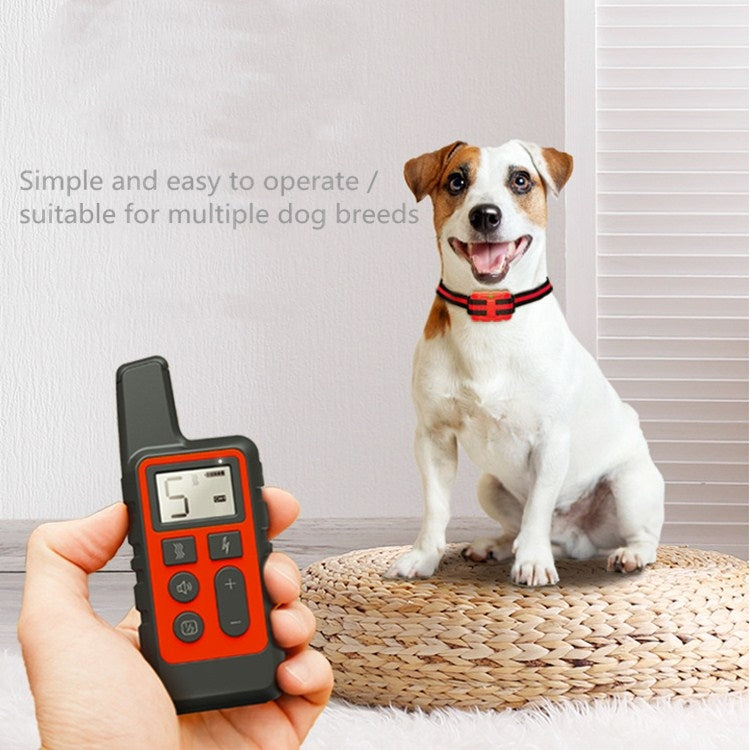Red handheld dog training remote control with LCD display and control buttons