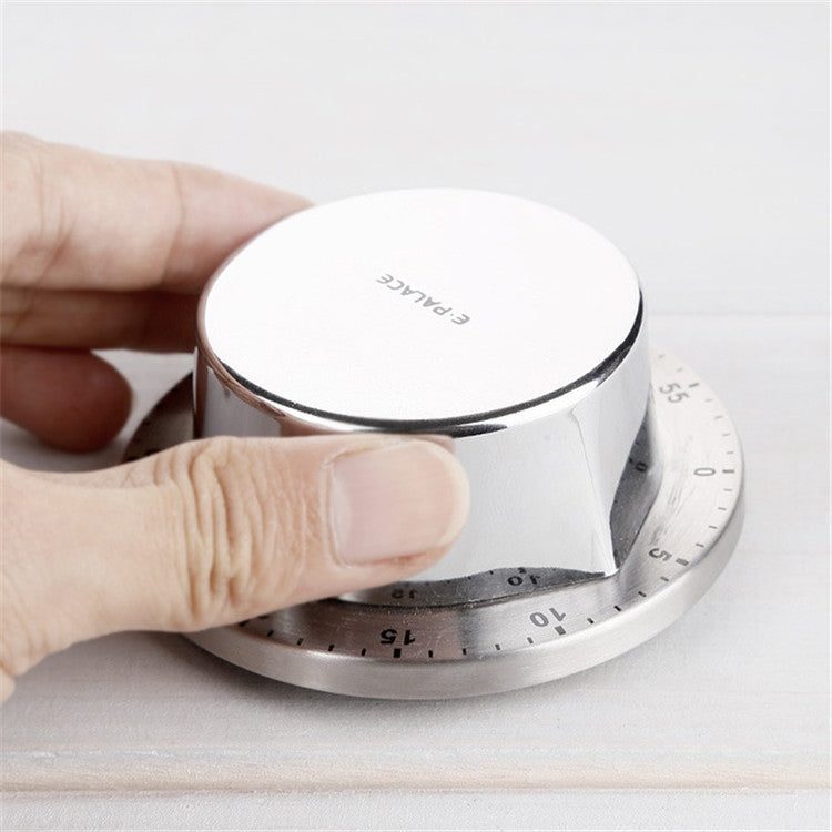 Magnetic timer top in hand over stainless numbered countdown dial