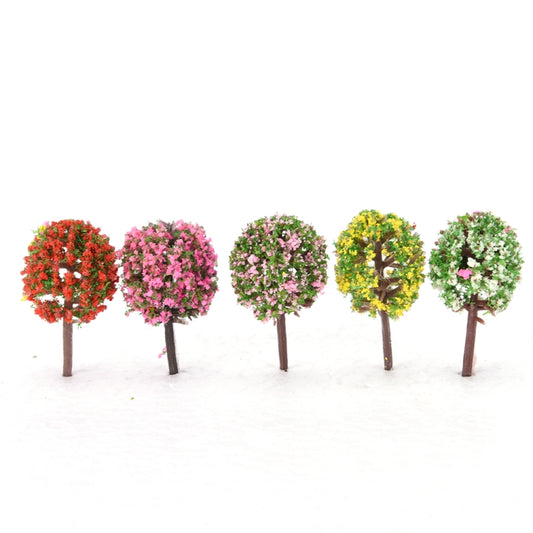 Mini artificial trees lineup with round multicolor foliage on brown trunks