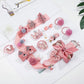Girls hair accessories set with pink bow clips, pom-pom bands, and hair ties