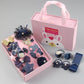 Girls hair accessories set in navy box with bows, pom-pom bands, and hair ties