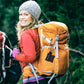 Orange CPR face shield key ring pouch attached to a backpack