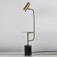 Floor lamp with gold gooseneck stand, cylindrical shade, and white marble base.