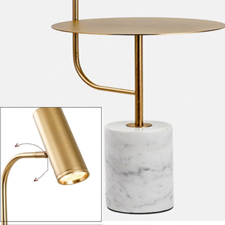 White marble base floor lamp with round top and gold cylindrical spotlight head.