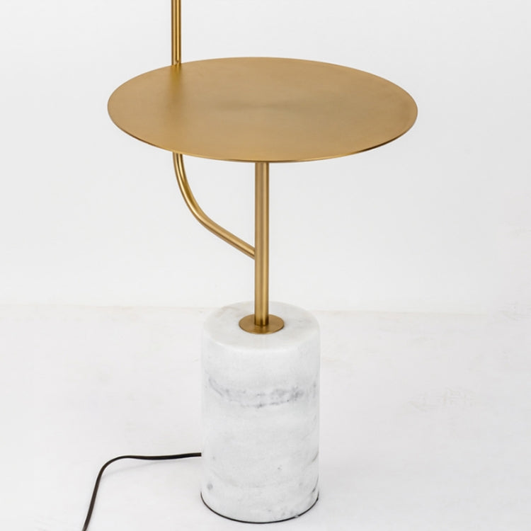 Round gold top floor lamp with white marble cylinder base and curved gold support.