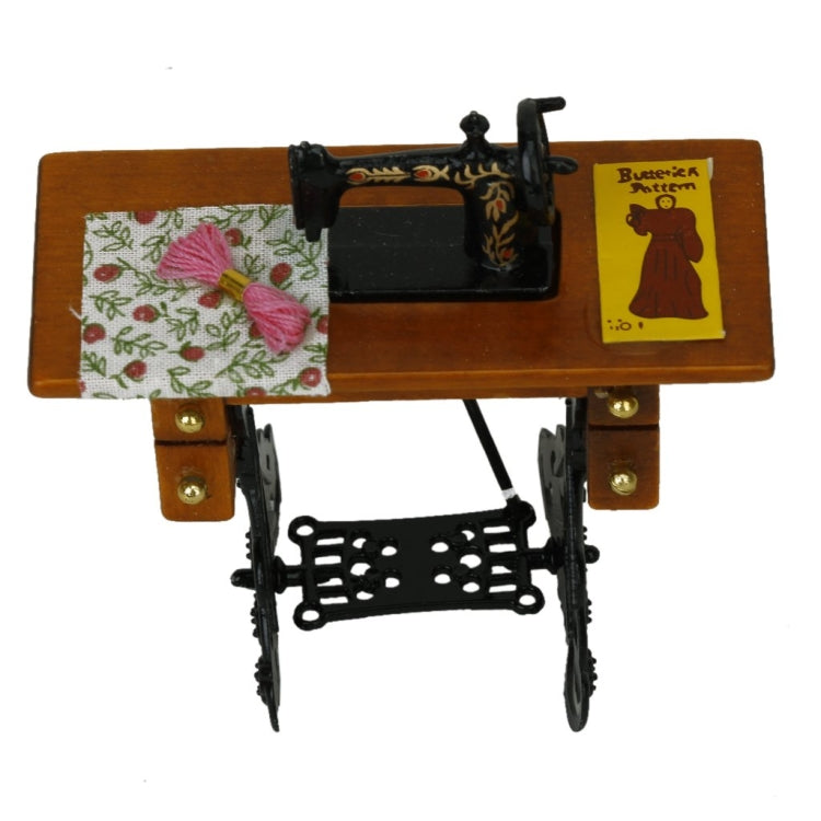 Mini sewing machine dollhouse table with floral fabric, yellow card, and black frame