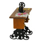 Mini sewing machine dollhouse table with floral cloth on top and round handwheel