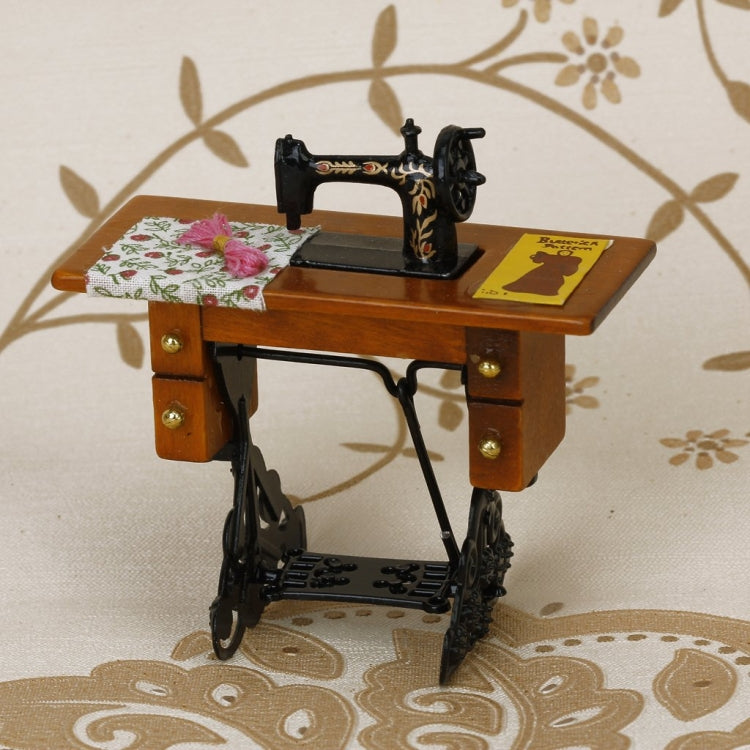 Mini sewing machine dollhouse table with floral fabric and black foot pedal frame