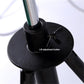 Black lamp base with lift adjustment button on tripod floor stand