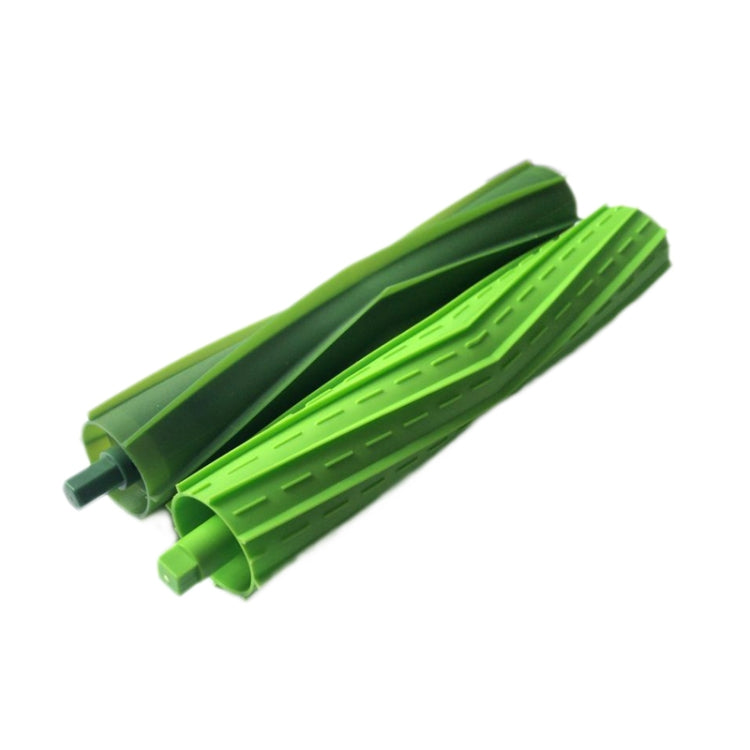 Pair of green robot main sweep brushes, angled view showing long ribbed bristles.