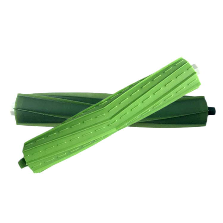 Pair of green robot main sweep brushes crossed, ribbed sweeping blades detail.