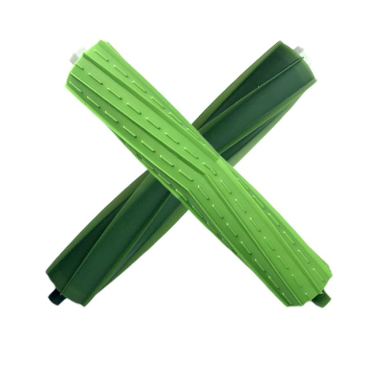 Pair of green robot main sweep brushes crossed, showing end caps and ribbing.