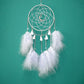 Green hoop dream catcher wall hanging with white feather fringe and dangling chains, no lights