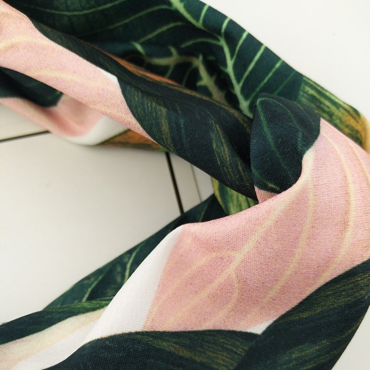 Leaf-pattern turban headband fabric detail with green and pink striped sections