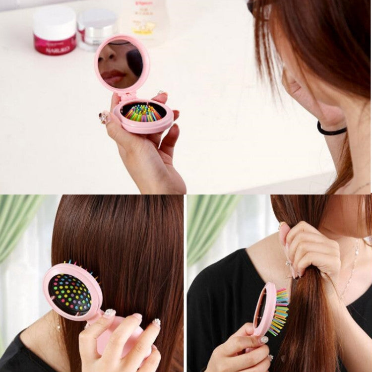 Pink folding massage mirror comb shown in use with colorful bristle brush and mirror