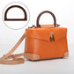 D-shaped dark brown wooden handbag handle on orange bag, metal clasp